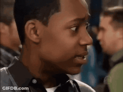 Man's Face Close Up With Group Behind Him GIF
