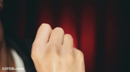 Man's Face Close Up With Red Curtain GIF