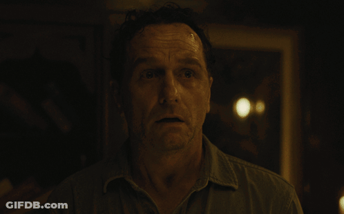 Man's Face In Dark Blurred Room GIF