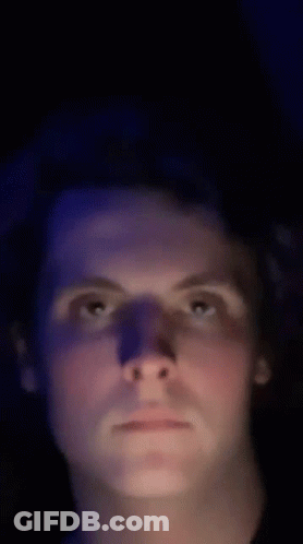 Man's Face In Dark Room With Blue Light GIF