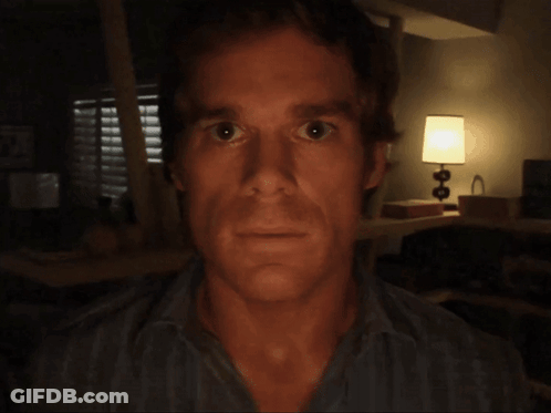 Man's Face In Dark Room With Lamp GIF