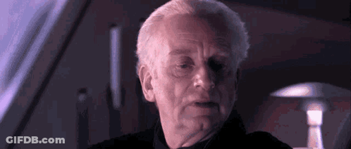 Man's Face In Dark Room With Lamp GIF