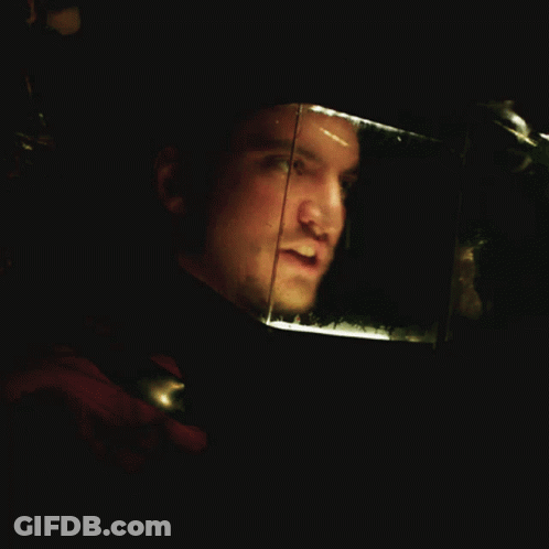 Man's Face In Dark Room With Reflection GIF