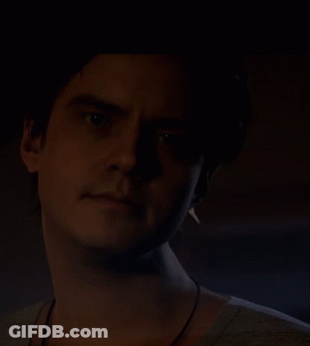 Man's Face In Dark Room GIF