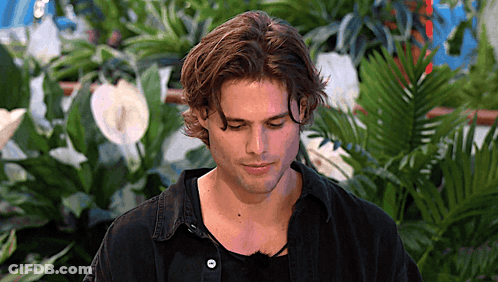 Man's Face In Front Of Plants GIF