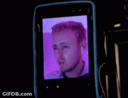 Man's Face On Cell Phone Screen GIF