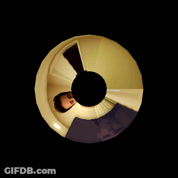 Man's Face Reflected In Black Circle GIF