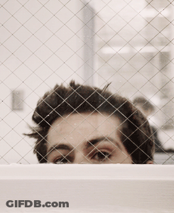 Man's Face Through Wire Fence GIF