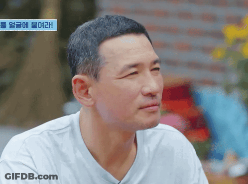 Man's Face With Blue Sign Saying Korean GIF