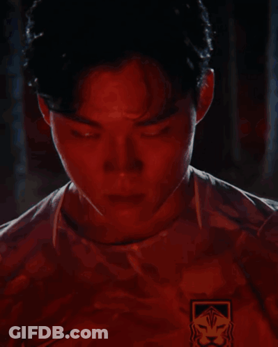 Man's Face With Red Lights Behind GIF
