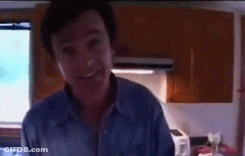 Man's Face With Reflection In Dark Room GIF