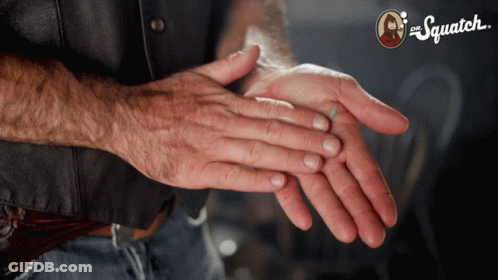 Man's Hands In Front Of Squatch Sign GIF