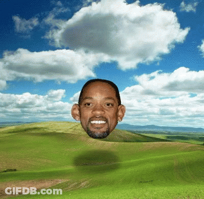 Man's Head Floating Above Green Field GIF