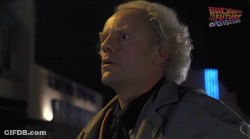 Man Saying Great Scott In Front Of Back To The Future Poster GIF