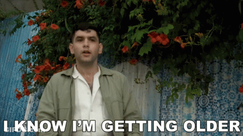 Man Saying I Know I'm Getting Older In Front Of Flowers GIF