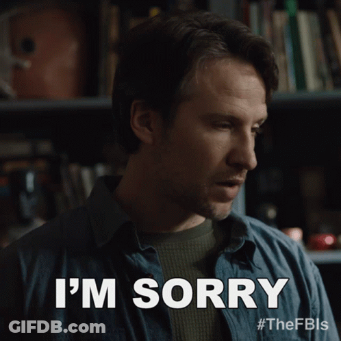 Man Saying I'm Sorry In Front Of Bookcase GIF