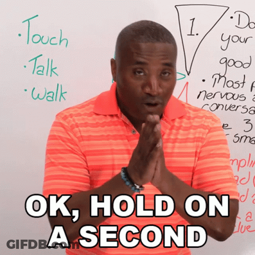Man Saying Ok Hold On A Second In Front Of Whiteboard GIF