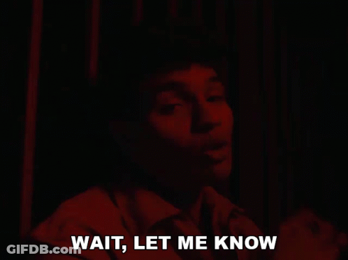 Man Saying Wait In Dark Room GIF