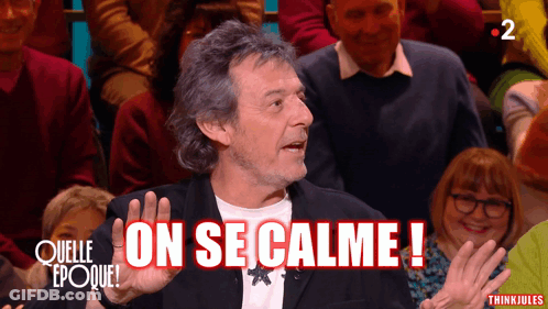 Man Says On Se Calme In Front Of Crowd GIF