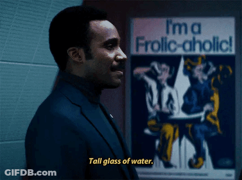 Man Says Tall Glass Of Water In Front Of I'm A Frolic-Aholic Poster GIF