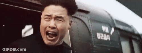 Man Screaming In Front Of Train With Chinese Writing GIF