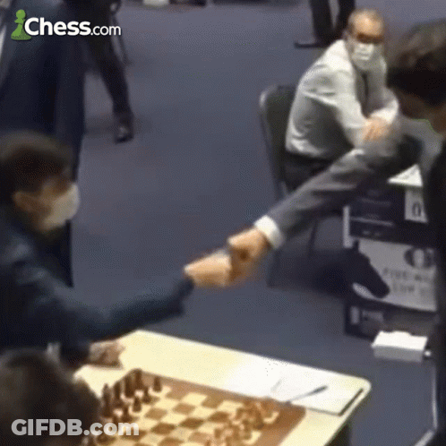 Man Shaking Hands In Front Of Chessboard GIF