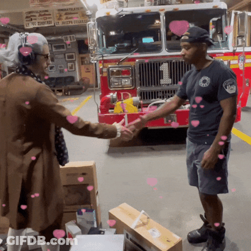 Man Shaking Hands With Fireman In Front Of Fire Truck Number 1 GIF