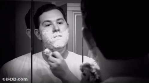 Man Shaving In Front Of Mirror GIF