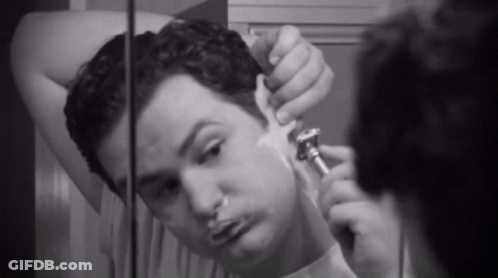 Man Shaving In Front Of Mirror GIF