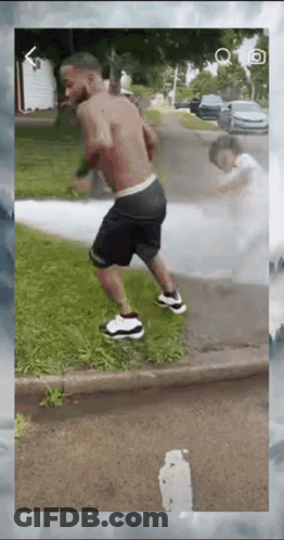 Man Shirtless Walking Down Street GIF
