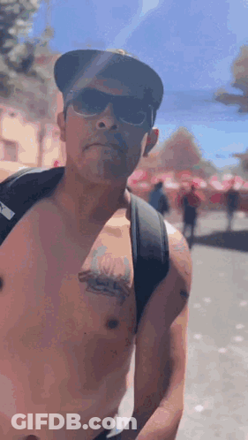 Man Shirtless Wearing Sunglasses Hat Backpack GIF