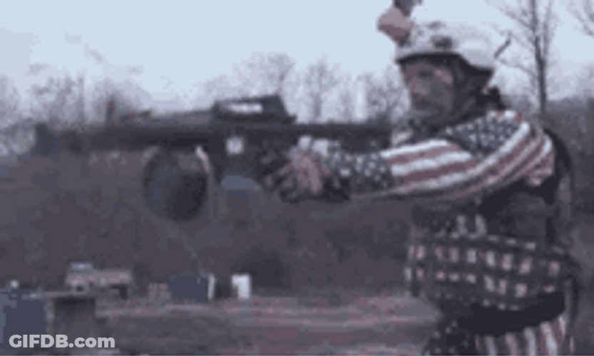 Man Shooting Two Blazing Guns GIF