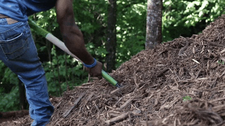 Man Shoveling Mulch GIF
