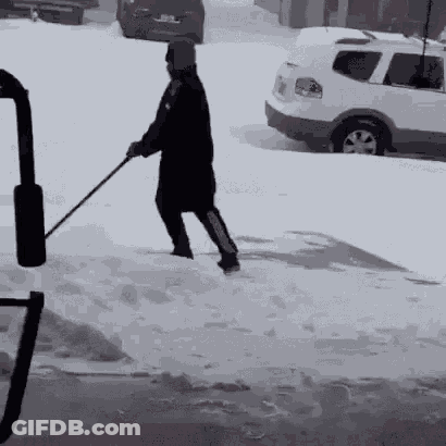 Man Shoveling Snow In Front Of White SUV GIF