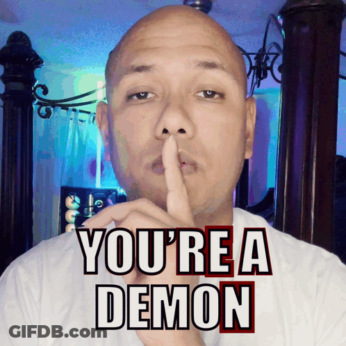 Man Shushing With You're A Demon Behind Him GIF