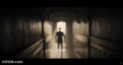 Man Silhouette Walking Hallway GIF