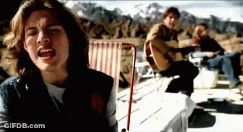 Man Singing And Playing Guitar Beside Seated Man GIF