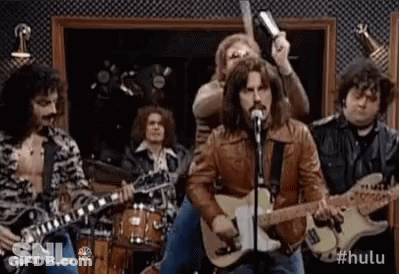 Man Singing Guitar Into Microphone With Drummers GIF