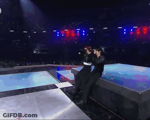 Man Singing In Red Jacket And Gold Necklace GIF