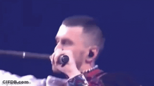 Man Singing Into Microphone Blue Background GIF