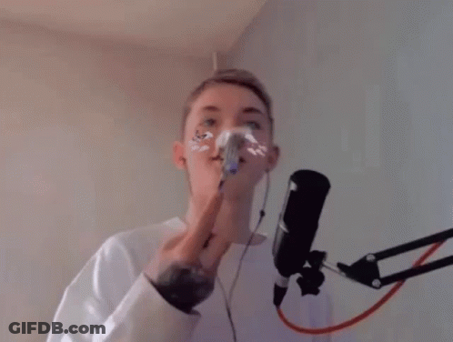 Man Singing Into Microphone Holding Fork In Mouth GIF
