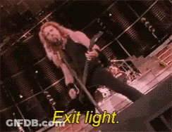Man Singing Into Microphone Holding Guitar Exit Light GIF