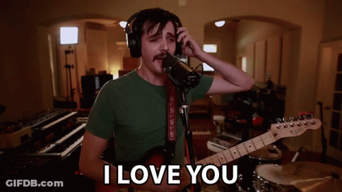 Man Singing Into Microphone Holding Guitar Saying I Love You GIF