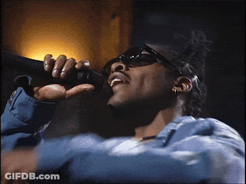 Man Singing Into Microphone In Blue Jacket GIF