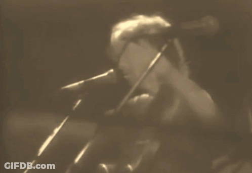 Man Singing Into Microphone In Dark Room GIF