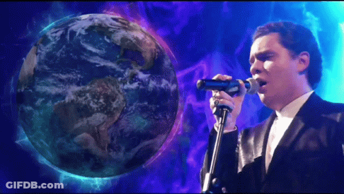 Man Singing Into Microphone In Front Of Globe GIF