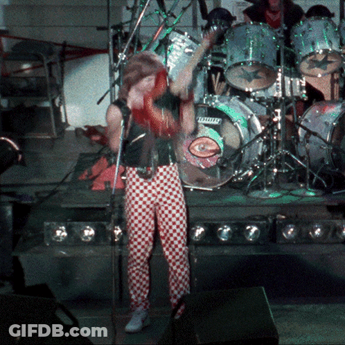 Man Singing Into Microphone In Front Of Ludwig Drum Set GIF
