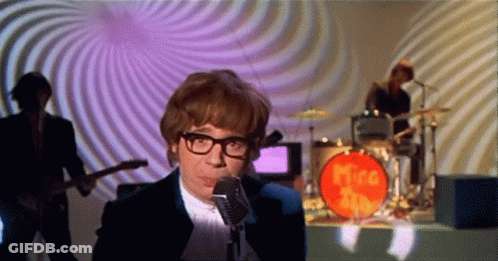 Man Singing Into Microphone In Front Of Mira Band GIF