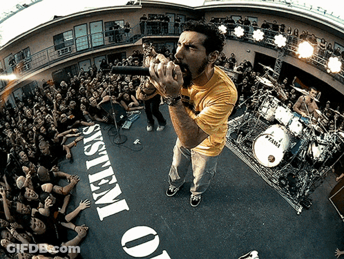Man Singing Into Microphone In Front Of System Of O GIF