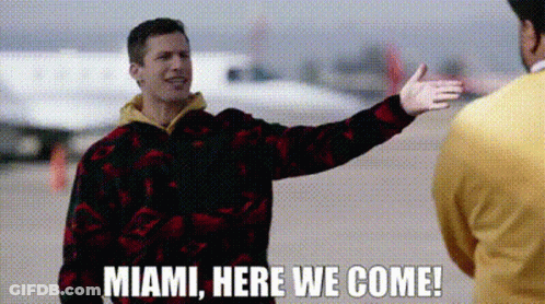 Man Singing Into Microphone In Front Of Welcome To Miami Sign GIF